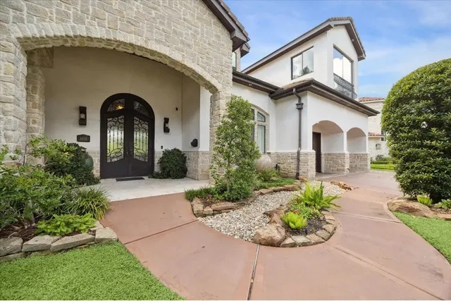 a front view of a house with garden