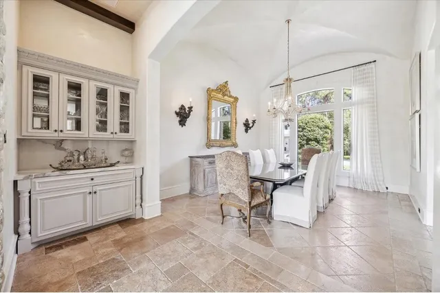 a living room with kitchen island furniture and a chandelier
