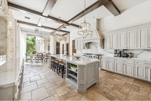 a kitchen with stainless steel appliances granite countertop a sink and cabinets