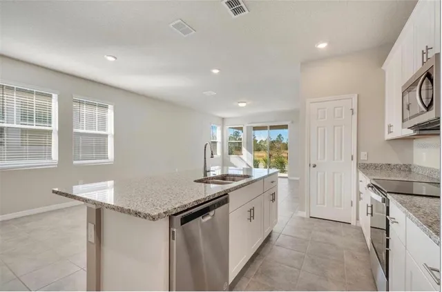 a kitchen with a sink stove and cabinets