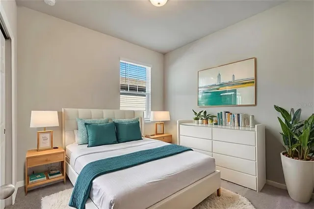 a bedroom with a bed and a potted plant