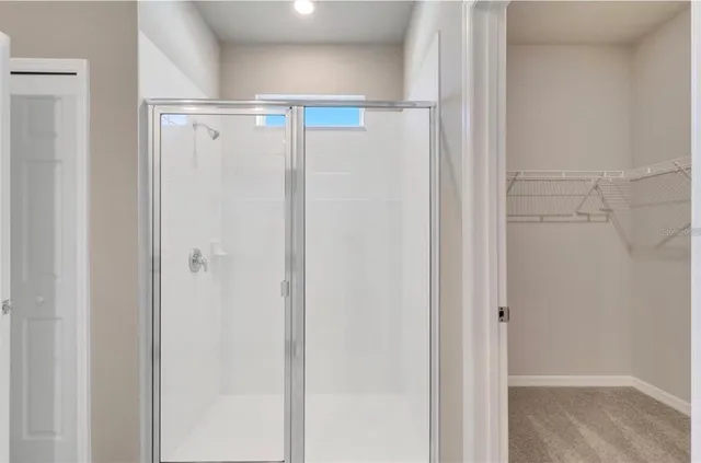 a balcony with furniture and a floor to ceiling window