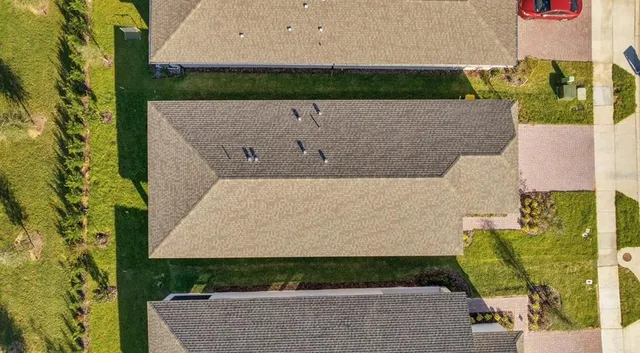 an aerial view of a house with a yard