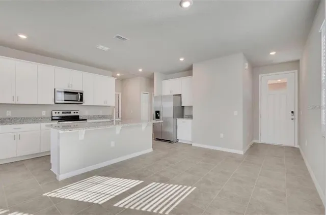 a kitchen with white cabinets and white appliances