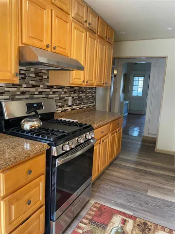 a kitchen with stainless steel appliances granite countertop a stove and a sink