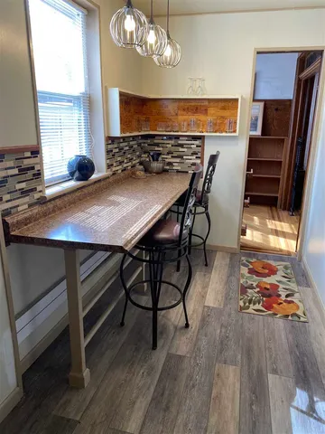 a view of a dining room with furniture and a chandelier