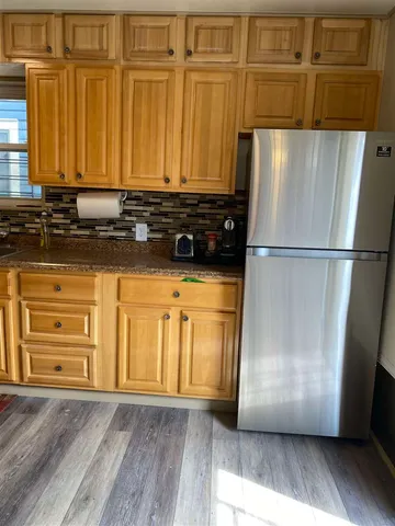 a view of a refrigerator with wooden floor