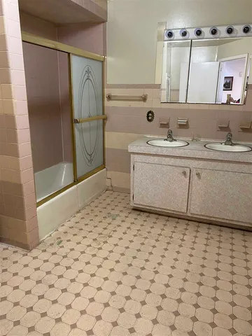 a bathroom with a sink a vanity and a mirror