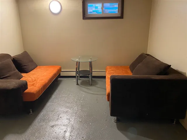 a bedroom with a bed and chair