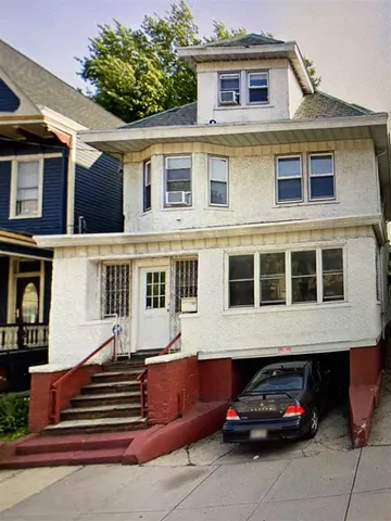 a front view of a house with a garden