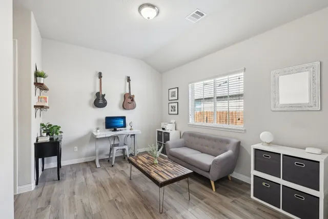 a living room with furniture and wooden floor