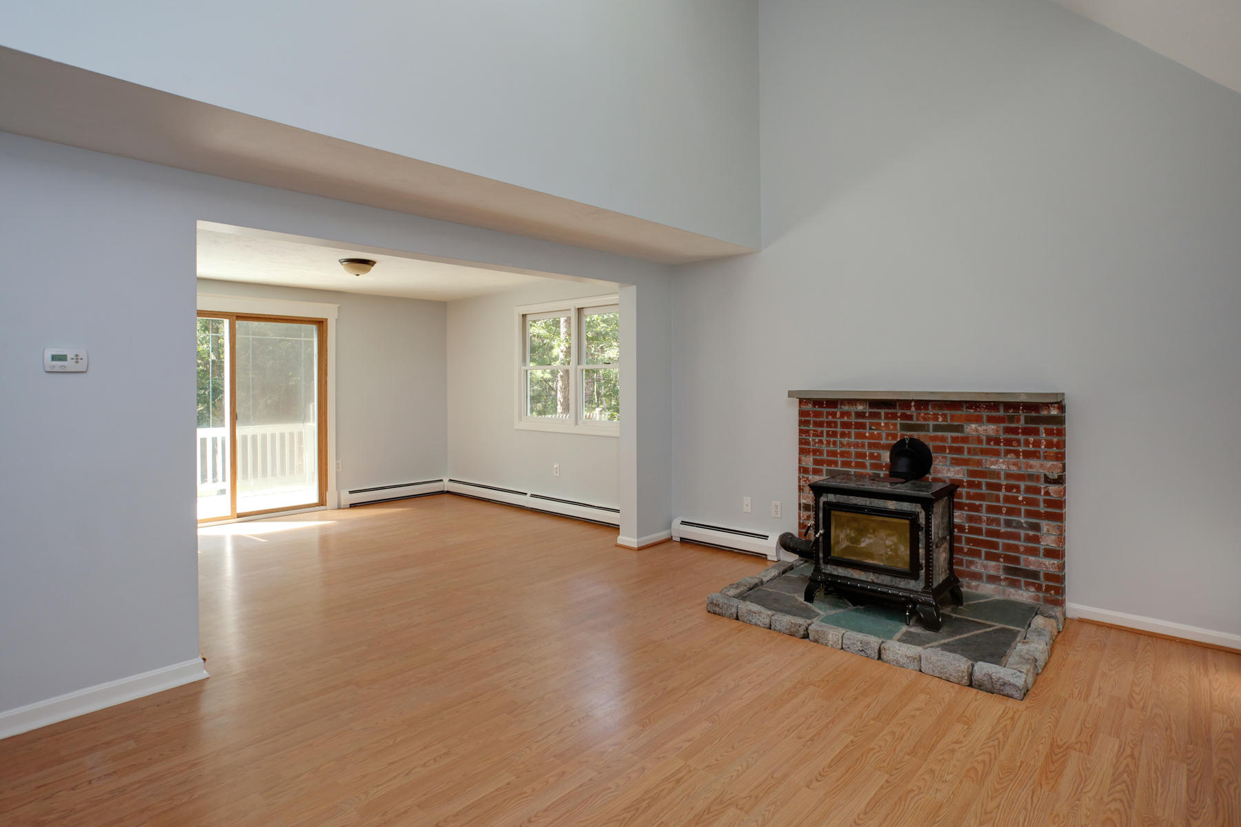 215 Simon Narrows Road Mashpee, MA 02649 - Photo 4 of 20 a view of empty room with wooden floor and fireplace
