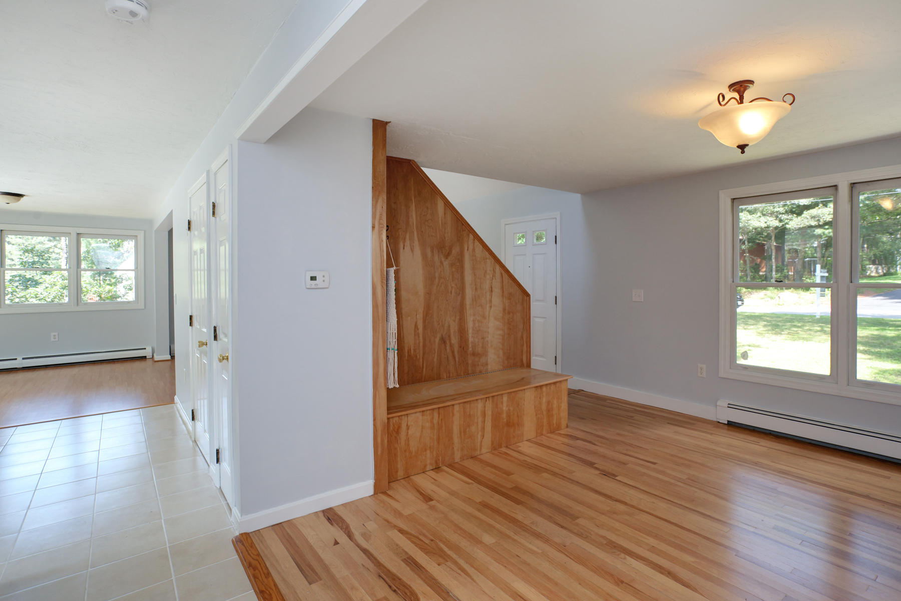 215 Simon Narrows Road Mashpee, MA 02649 - Photo 8 of 20 an empty room with wooden floor and windows