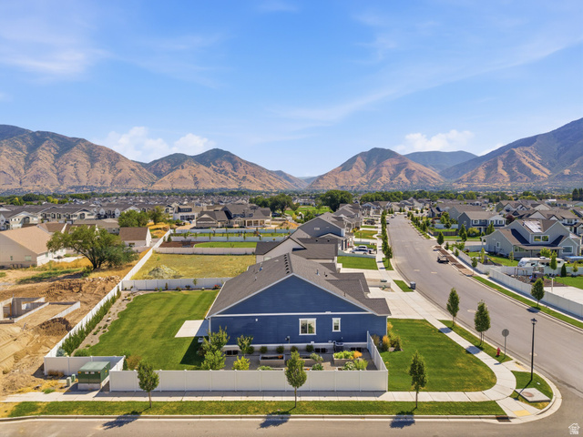 2786 West Hancock Street, Unit 198 Mapleton, UT 84664 - Photo 26 of 33 Expansive property featuring a vibrant blue exterior, a large green lawn, and a white perimeter fence