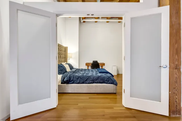 a bedroom with a bed and a mirror