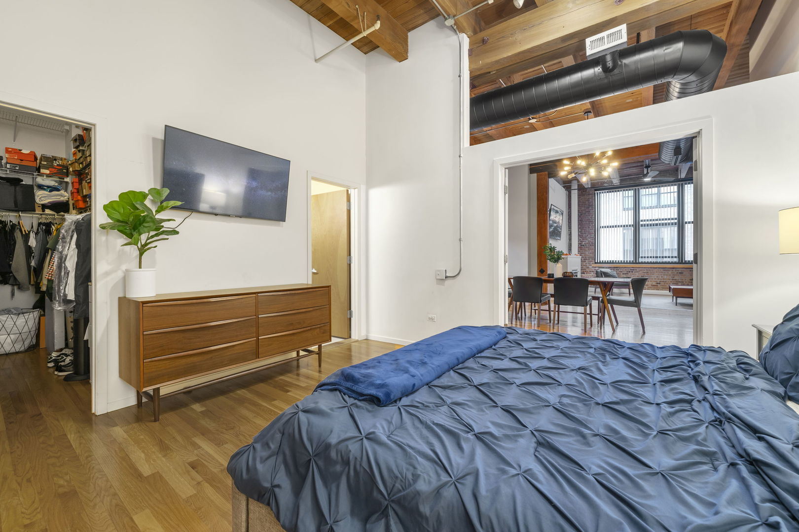 1727 South Indiana Avenue, Unit 320 Chicago, IL 60616 - Photo 19 of 28 a bedroom with a bed and a table in it