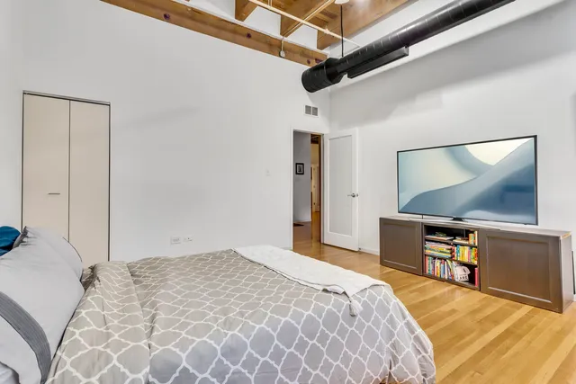 a bedroom with a bed and a flat screen tv
