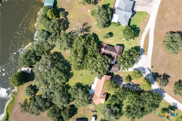 an aerial view of a house with a yard
