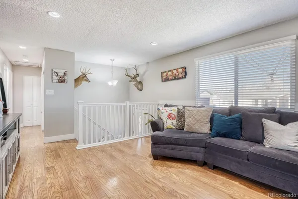 a living room with furniture kitchen view and a flat screen tv