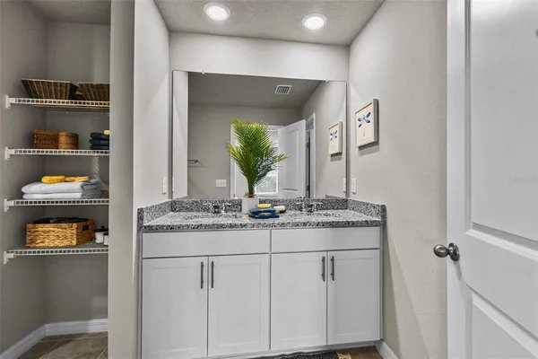 a bathroom with mirror and sink