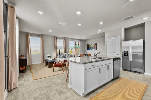 a large kitchen with kitchen island a sink stainless steel appliances and cabinets