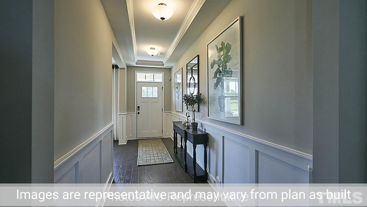 7704 Calcutta Drive Willow Spring, NC 27592 - Photo 2 of 30 a view of a hallway with wooden floor and staircase