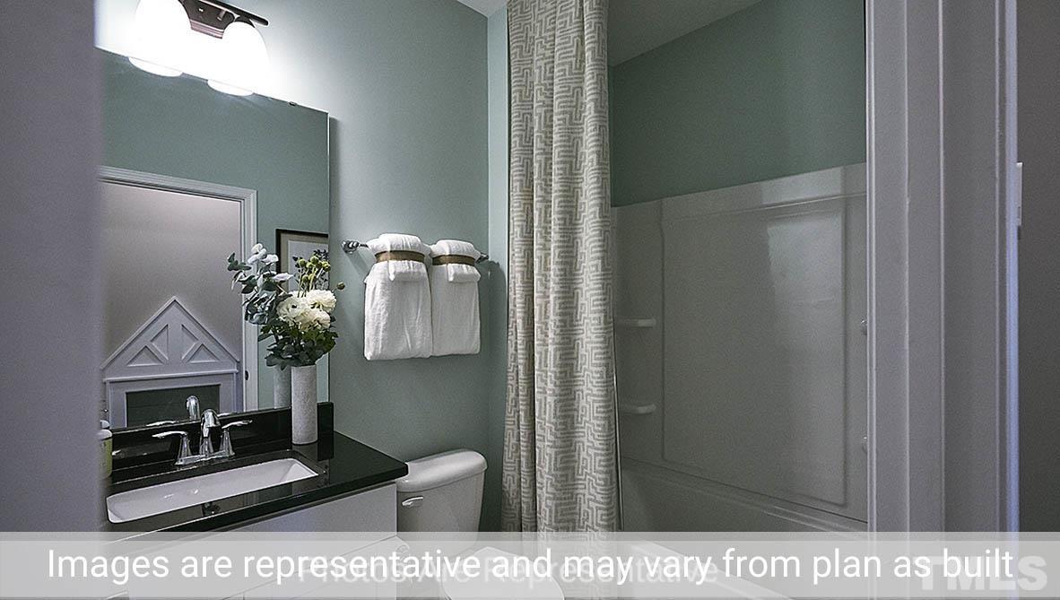 7704 Calcutta Drive Willow Spring, NC 27592 - Photo 15 of 30 a picture of a bathroom with a sink and a mirror