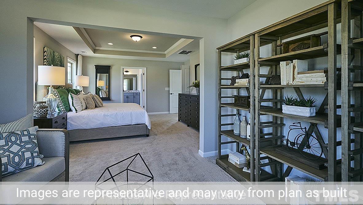 7704 Calcutta Drive Willow Spring, NC 27592 - Photo 26 of 30 a bedroom with furniture and a book shelf