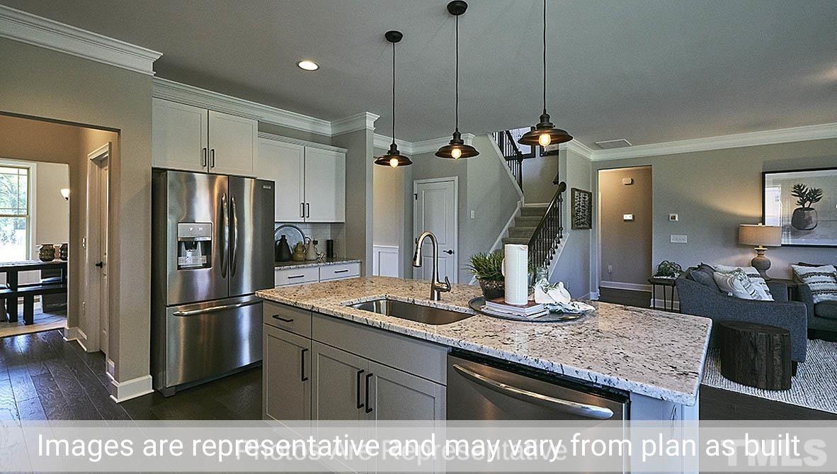 7704 Calcutta Drive Willow Spring, NC 27592 - Photo 7 of 30 a kitchen with refrigerator and sink