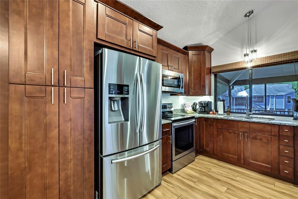 2919 North Rivers Edge Boulevard, Unit 2919 Crystal River, FL 34429 - Photo 12 of 36 a kitchen with stainless steel appliances granite countertop a refrigerator and a sink