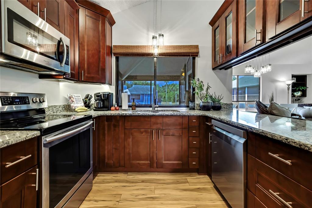 2919 North Rivers Edge Boulevard, Unit 2919 Crystal River, FL 34429 - Photo 13 of 36 a kitchen with stainless steel appliances granite countertop a stove and a sink