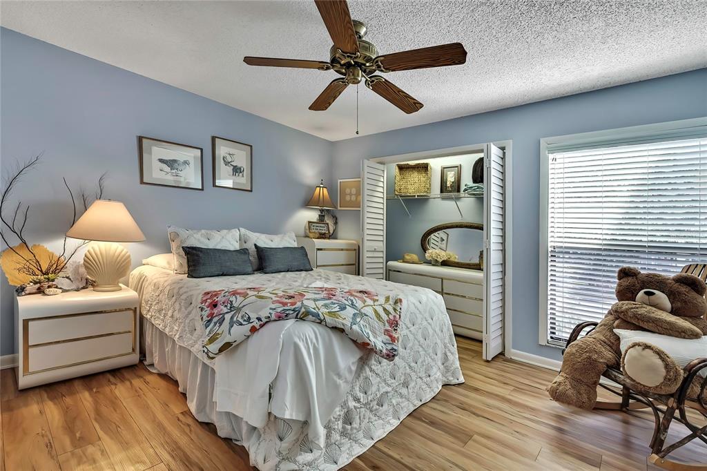 2919 North Rivers Edge Boulevard, Unit 2919 Crystal River, FL 34429 - Photo 15 of 36 a bedroom with a bed and wooden floor