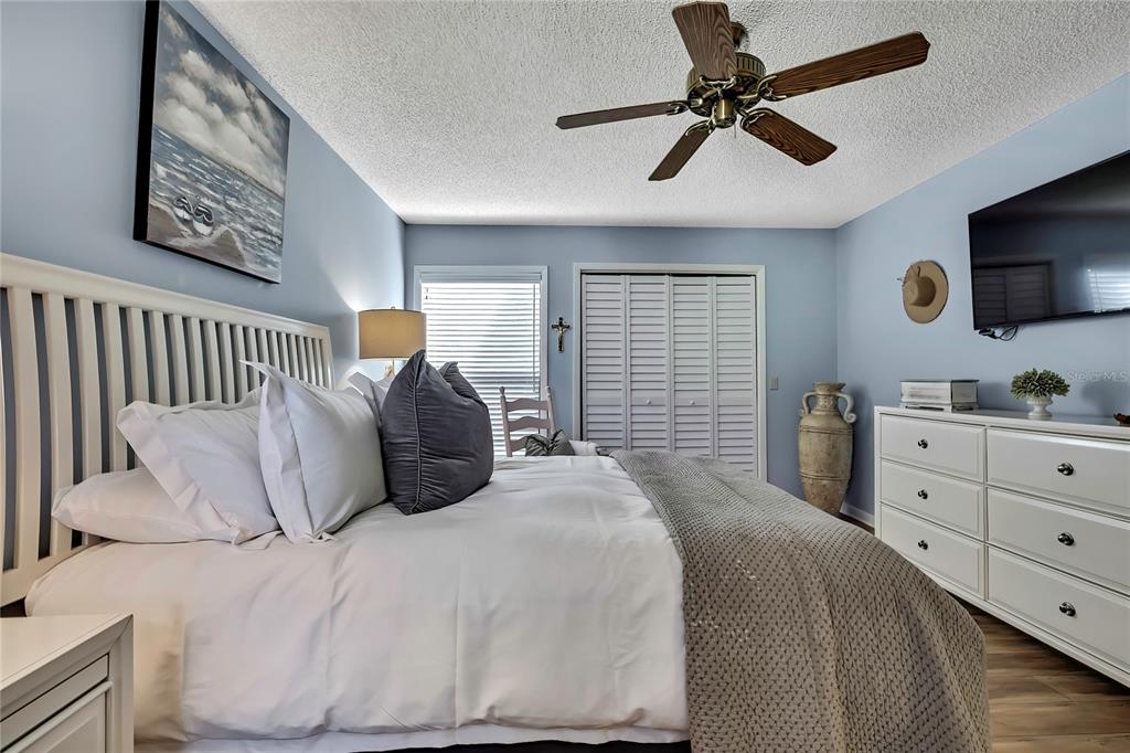 2919 North Rivers Edge Boulevard, Unit 2919 Crystal River, FL 34429 - Photo 20 of 36 a bedroom with a bed a window and a flat screen tv