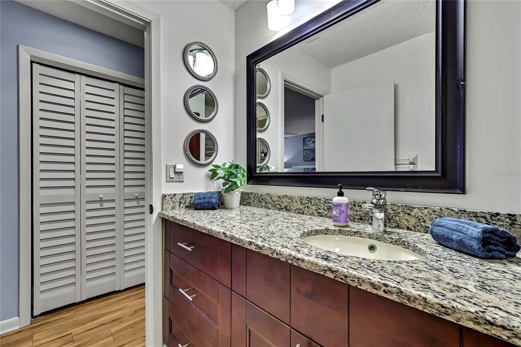 2919 North Rivers Edge Boulevard, Unit 2919 Crystal River, FL 34429 - Photo 23 of 36 a bathroom with a granite countertop sink and a mirror