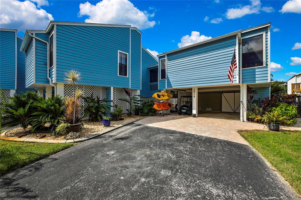 2919 North Rivers Edge Boulevard, Unit 2919 Crystal River, FL 34429 - Photo 29 of 36 a view of a house with sitting area and a yard