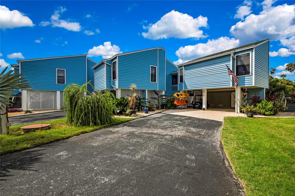 2919 North Rivers Edge Boulevard, Unit 2919 Crystal River, FL 34429 - Photo 31 of 36 a front view of a house with a yard and garage