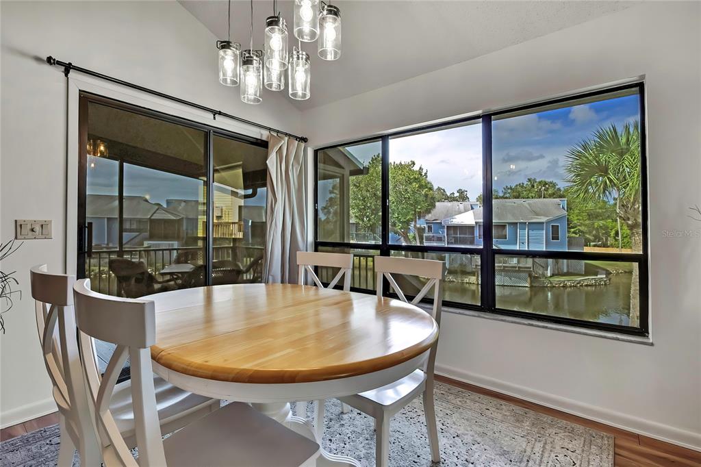 2919 North Rivers Edge Boulevard, Unit 2919 Crystal River, FL 34429 - Photo 6 of 36 a dining room with furniture a chandelier and window