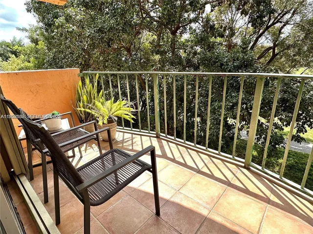 a view of a balcony with chairs