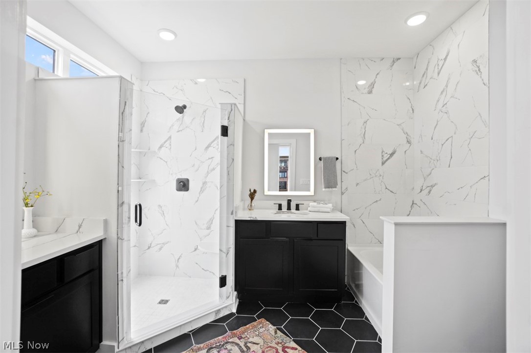 2291 West 19th Street Cleveland, OH 44113 - Photo 22 of 47 Bathroom with plus walk in shower, vanity, and tile patterned flooring