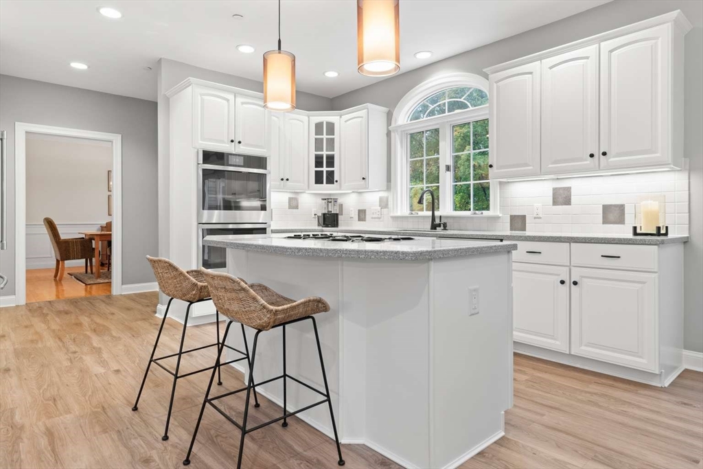 85 Windkist Farm Road North Andover, MA 01845 - Photo 4 of 20 a kitchen with stainless steel appliances kitchen island granite countertop a stove a sink and a refrigerator