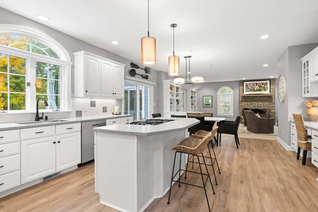 85 Windkist Farm Road North Andover, MA 01845 - Photo 6 of 20 a open kitchen with stainless steel appliances granite countertop a stove a sink dishwasher a refrigerator and white cabinets with wooden floor