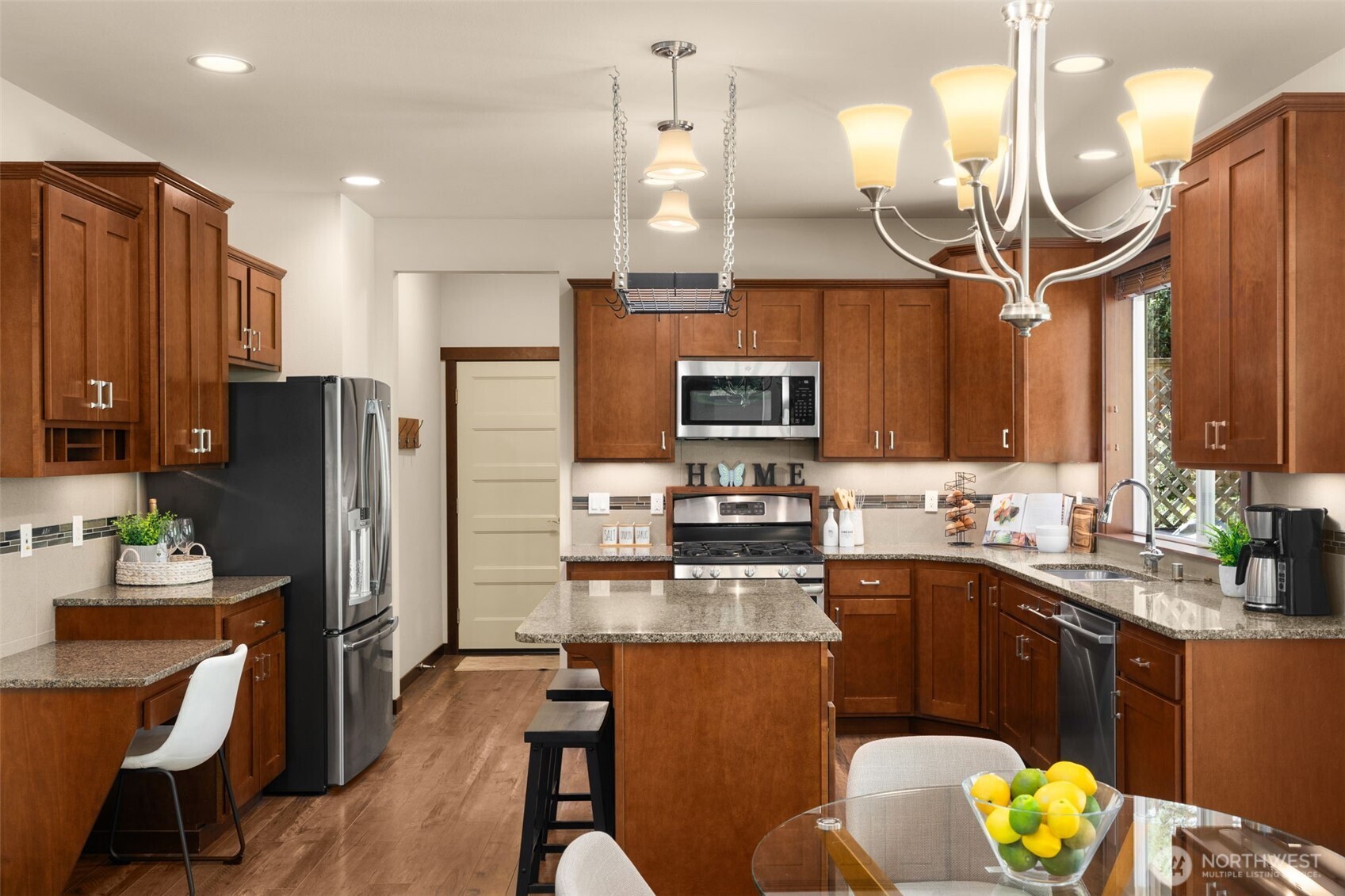 4610 Maltby Road Bothell, WA 98021 - Photo 12 of 39 a kitchen with stainless steel appliances kitchen island granite countertop a sink refrigerator and cabinets