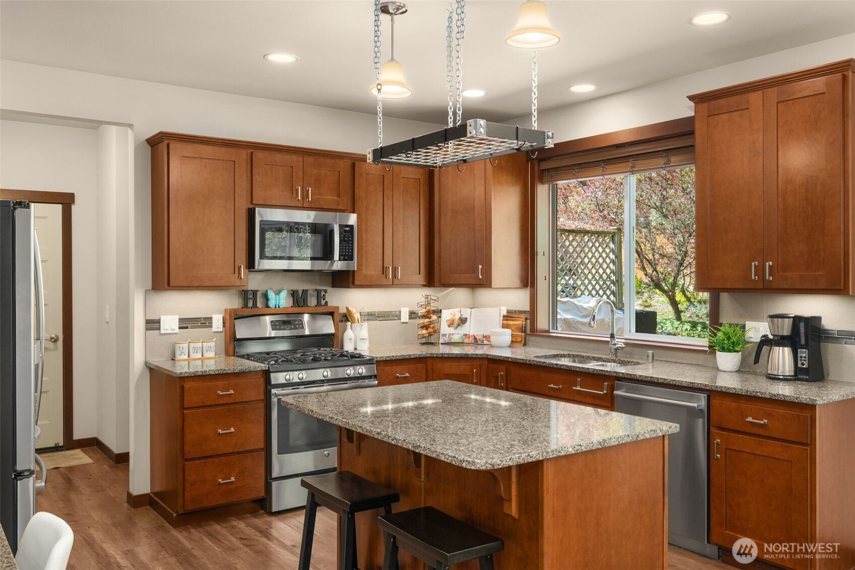 4610 Maltby Road Bothell, WA 98021 - Photo 13 of 39 a kitchen with a stove a sink a microwave a refrigerator and cabinets