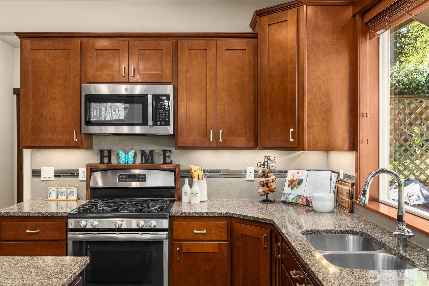 4610 Maltby Road Bothell, WA 98021 - Photo 14 of 39 a kitchen with granite countertop a stove a sink and a microwave