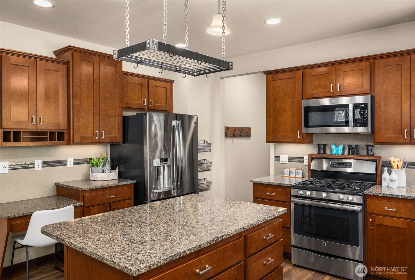 4610 Maltby Road Bothell, WA 98021 - Photo 15 of 39 a kitchen with stainless steel appliances granite countertop a stove refrigerator sink and microwave