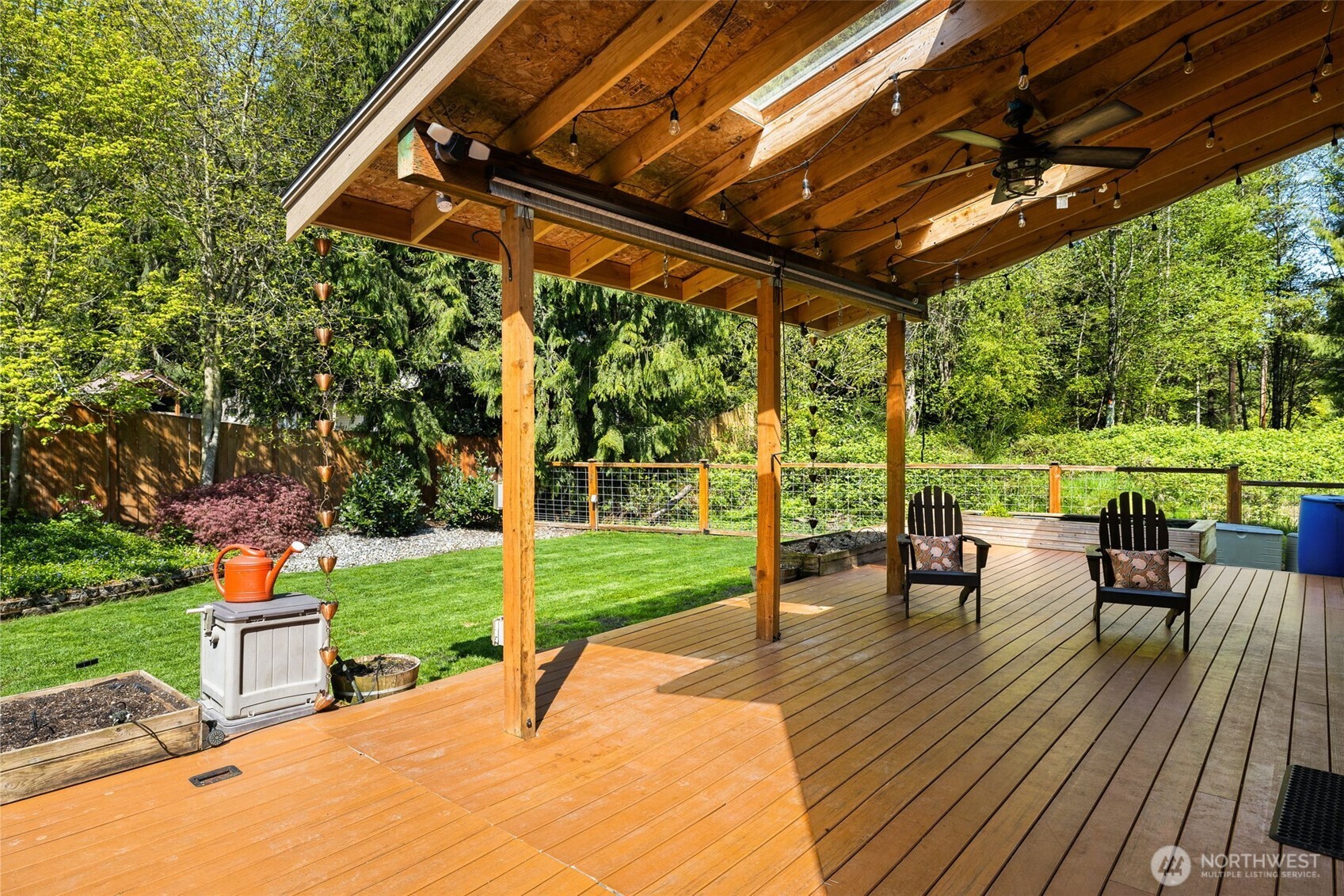 4610 Maltby Road Bothell, WA 98021 - Photo 33 of 39 a view of a patio with table and chairs potted plants and a big yard