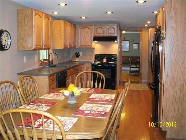 125 Bacon Road Ware, MA 01082 - Photo 7 of 30 a kitchen with stainless steel appliances kitchen island granite countertop a refrigerator a sink a stove and island
