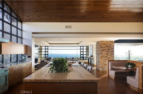 a kitchen with stainless steel appliances granite countertop a sink a stove and a wooden cabinets