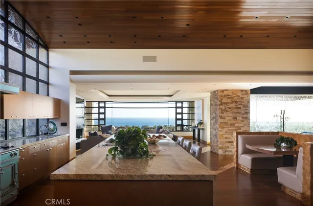 a kitchen with stainless steel appliances granite countertop a sink a stove and a wooden cabinets