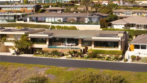 an aerial view of residential houses with outdoor space and river